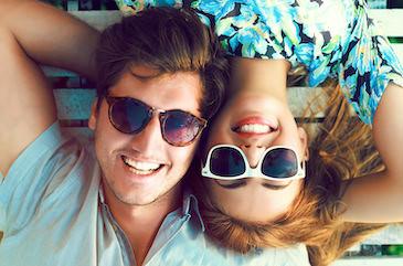 man and woman wearing sunglasses and smiling