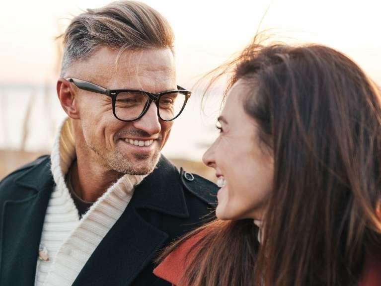 man with glasses smiling after having clear aligner treatment