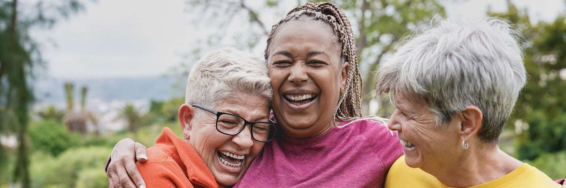 group of 3 women smiling and laughing 