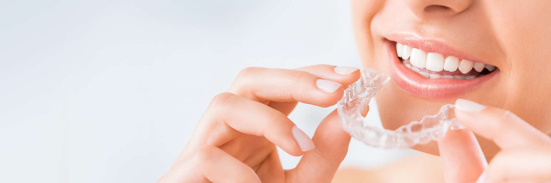 woman holding SureSmile® Clear Aligners 